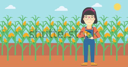 Farmer holding corn. Stock photo © RAStudio