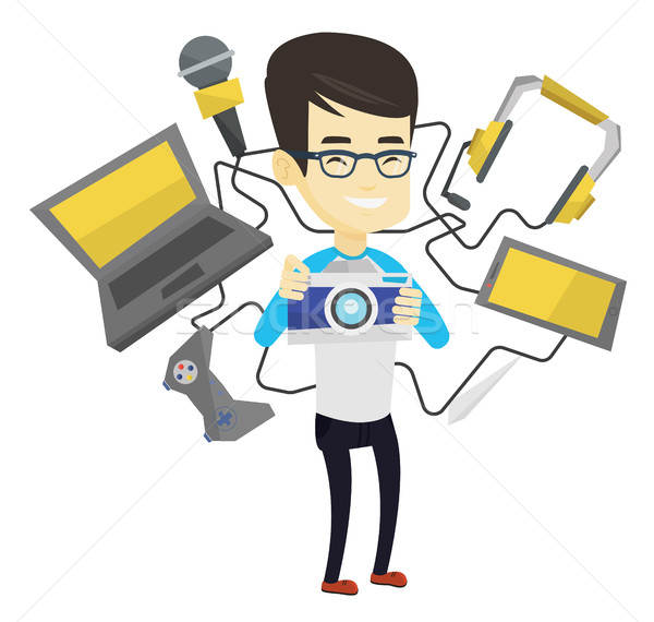 Young man surrounded with his gadgets. Stock photo © RAStudio