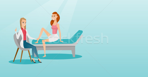 Gym doctor checking ankle of a patient. Stock photo © RAStudio