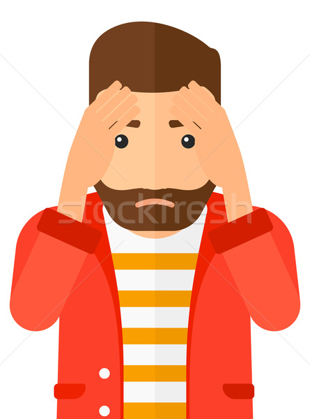 Stock photo: Repentant man clutching his head.