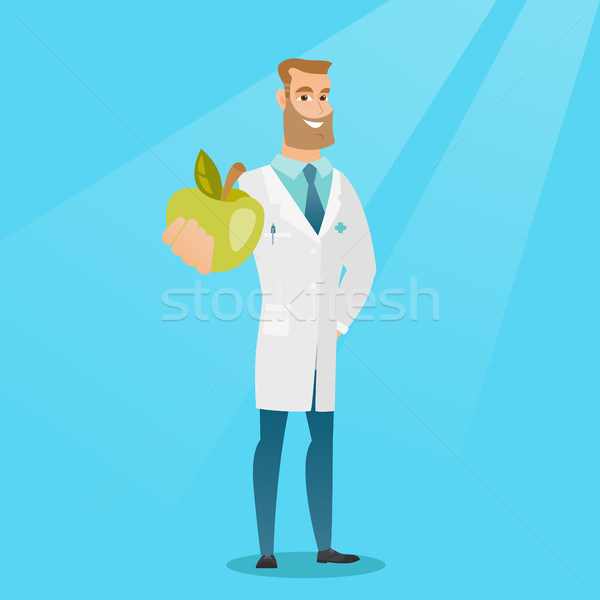 Nutritionist oferind proaspăt măr tineri caucazian Imagine de stoc © RAStudio