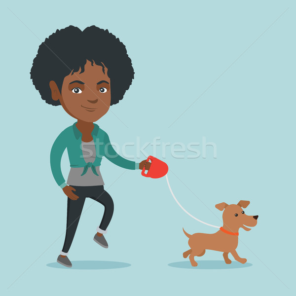Young african-american woman walking with her dog. Stock photo © RAStudio