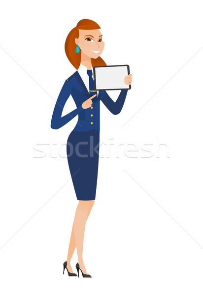 Smiling stewardess holding tablet computer. Stock photo © RAStudio