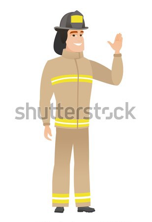 Stock photo: Firefighter standing with raised arms up.