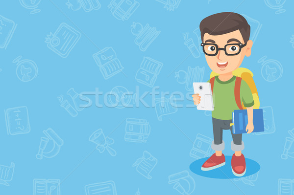 Caucasian boy holding cellphone and schoolbook. Stock photo © RAStudio