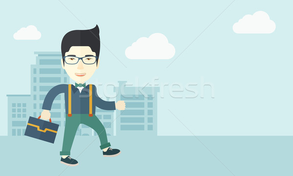 Young man walking through the city street with his briefcase. Stock photo © RAStudio