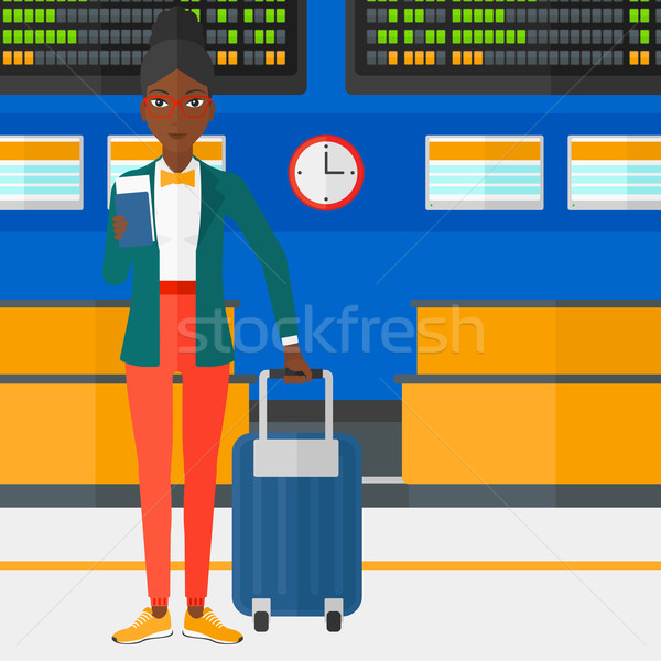 Woman standing with suitcase and holding ticket. Stock photo © RAStudio