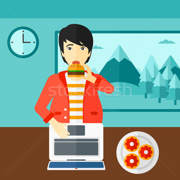 Man eating hamburger.  Stock photo © RAStudio