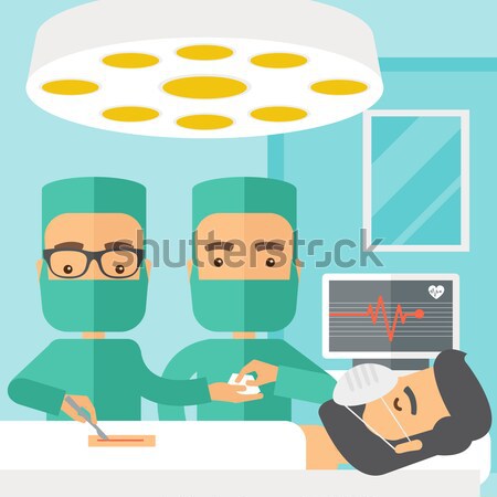 Two surgeons looking over a patient in an operating room Stock photo © RAStudio