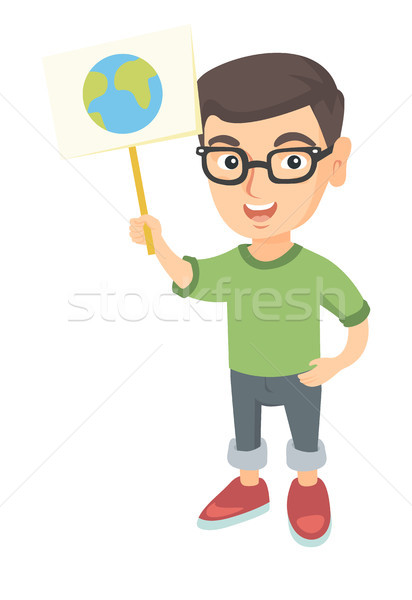 Caucasian boy holding a placard with planet. Stock photo © RAStudio