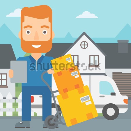 Delivery man with cardboard boxes. Stock photo © RAStudio