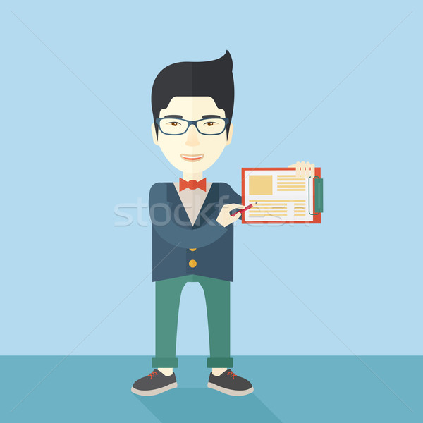 Handsome asian man wearing blue jacket holding his clipboard. Stock photo © RAStudio