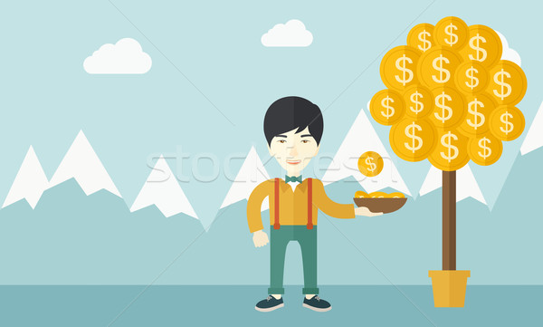 Stock photo: Successful chinese businessman standing while catching a dollar coin.