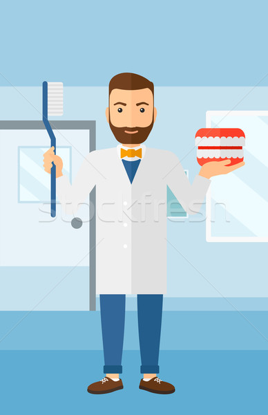 Dentist with dental jaw model and toothbrush. Stock photo © RAStudio