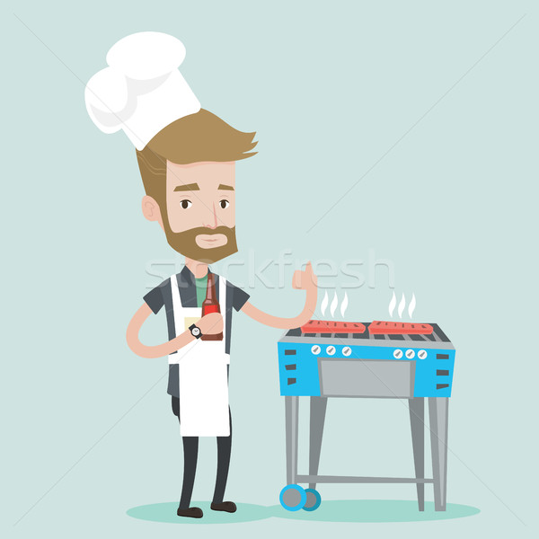 Man cooking meat on gas barbecue grill. Stock photo © RAStudio