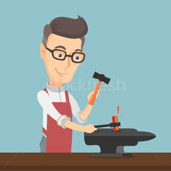 Blacksmith working metal with hammer on the anvil. Stock photo © RAStudio