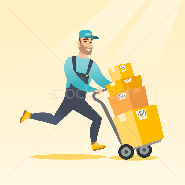 Delivery postman with cardboard boxes on trolley. Stock photo © RAStudio