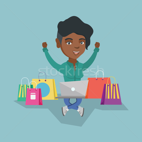 African woman using a laptop for online shopping Stock photo © RAStudio