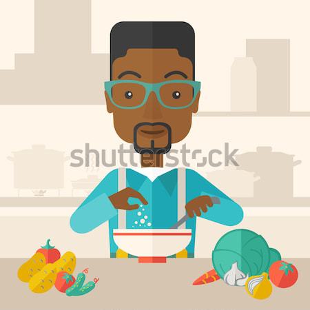 Stock photo: Young black guy is eating salad for lunch in the restaurant.