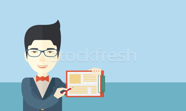 Handsome asian man wearing blue jacket holding his clipboard. Stock photo © RAStudio