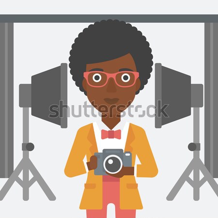 Smiling photographer holding camera. Stock photo © RAStudio