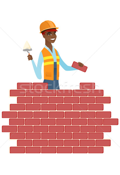 Bricklayer working with spatula and brick. Stock photo © RAStudio