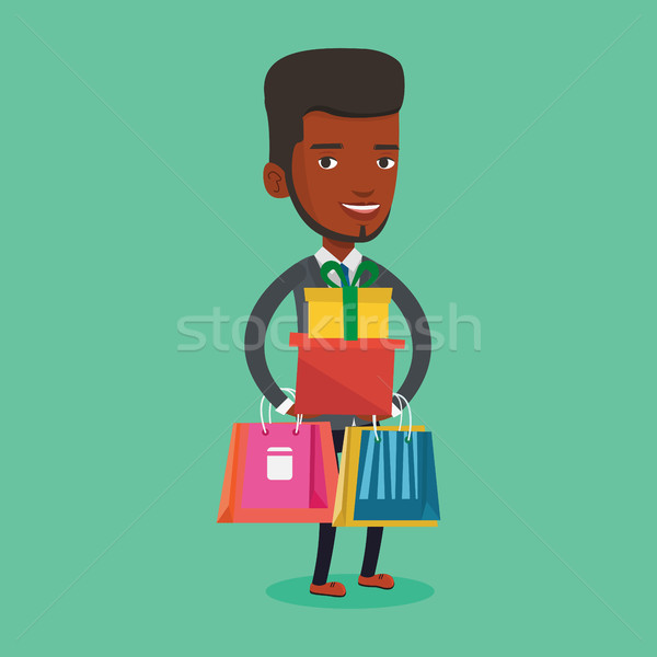 Happy man holding shopping bags and gift boxes. Stock photo © RAStudio