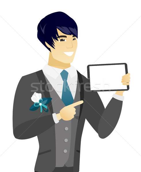 Young asian groom holding tablet computer. Stock photo © RAStudio