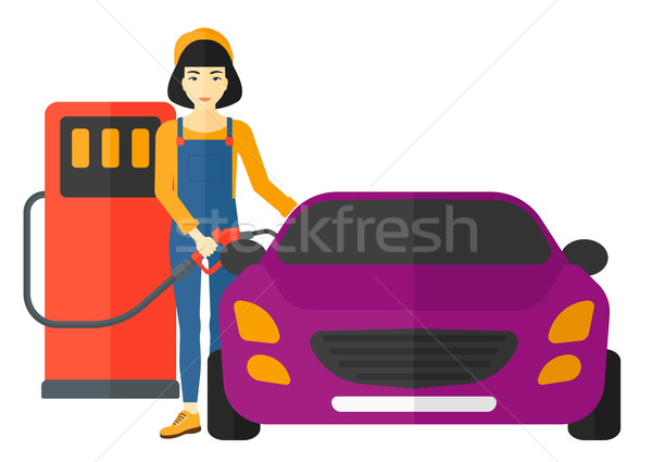 Stock photo: Woman filling up fuel into car.