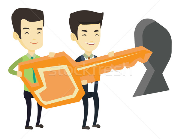 Business people holding key in front of keyhole. Stock photo © RAStudio