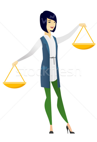 Asian business woman holding balance scale. Stock photo © RAStudio