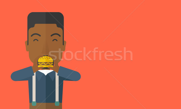 Man eating hamburger.  Stock photo © RAStudio