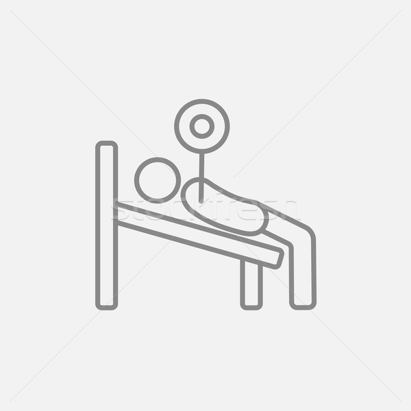 Man lying on bench and lifting barbell line icon. Stock photo © RAStudio