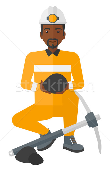 Miner holding coal in hands. Stock photo © RAStudio