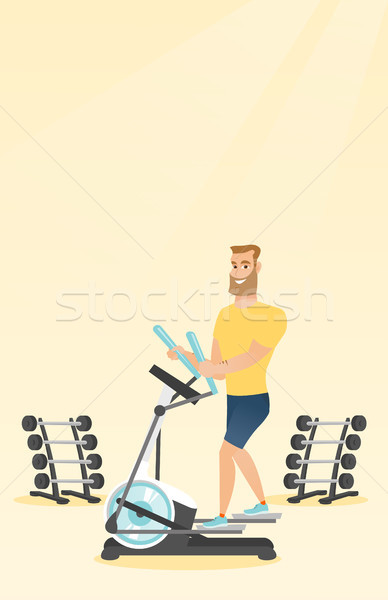 Man exercising on elliptical trainer. Stock photo © RAStudio