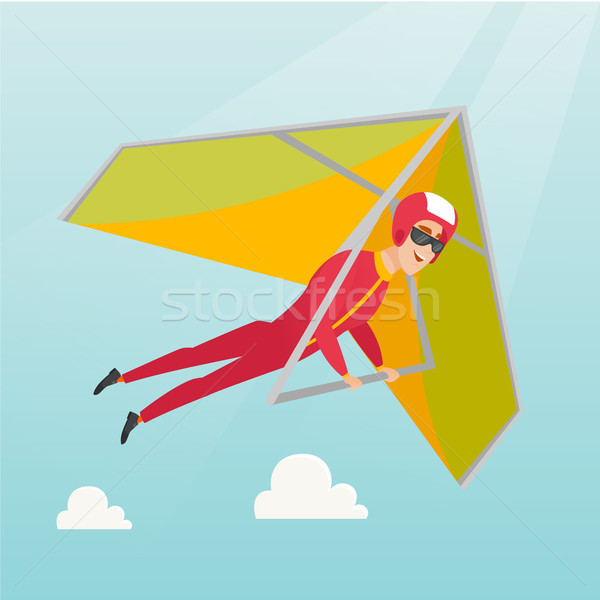 Young caucasian man flying on hang-glider. Stock photo © RAStudio