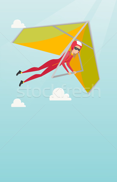 Young caucasian woman flying on hang-glider. Stock photo © RAStudio