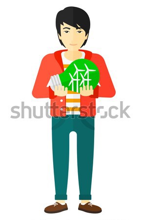 Man with lightbulb and windmill inside. Stock photo © RAStudio