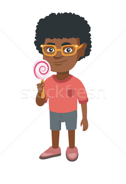 Little african boy holding a lollipop candy. Stock photo © RAStudio
