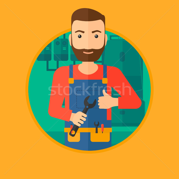 Cheerful repairman with spanner. Stock photo © RAStudio