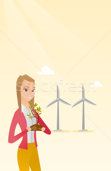 Woman holding small plant vector illustration. Stock photo © RAStudio
