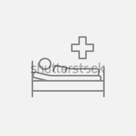 Patient lying on bed line icon. Stock photo © RAStudio