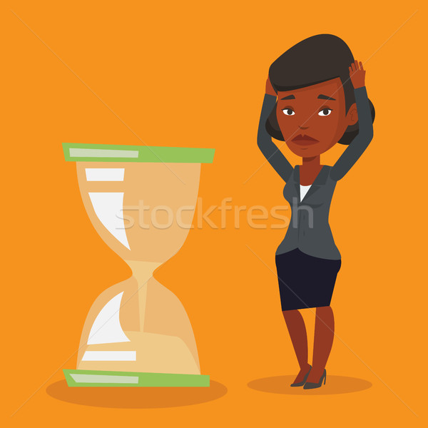 Stock photo: Desperate business woman looking at hourglass.