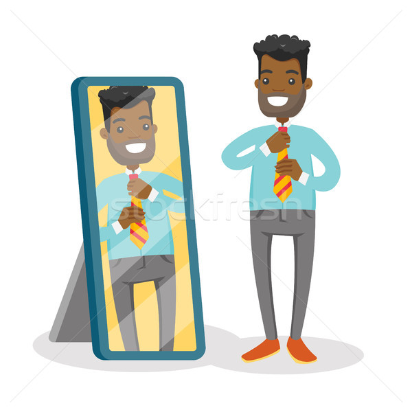 Stock photo: Businessman looking at himself in the mirror.