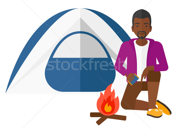 Man kindling fire. Stock photo © RAStudio