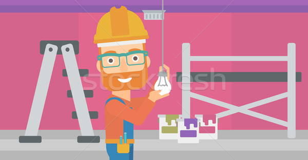 Electrician twisting light bulb. Stock photo © RAStudio