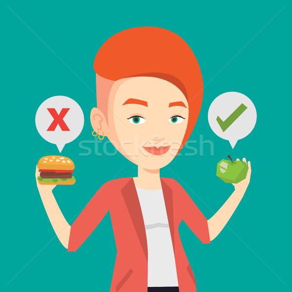 Woman choosing between hamburger and cupcake. Stock photo © RAStudio