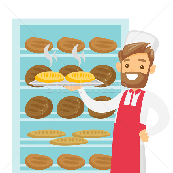 Caucasian white baker holding tray with bread. Stock photo © RAStudio