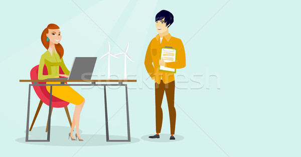 Multiracial engineers projecting wind turbines. Stock photo © RAStudio