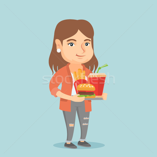 Caucasian woman holding tray full of fast food. Stock photo © RAStudio